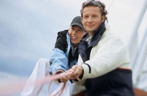 Couple on boat pulling rope